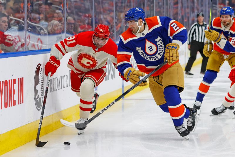 Feb 24, 2024; Edmonton, Alberta, CAN; Calgary Flames forward Name Kadri (91) and defensemen Evan Bouchard (2) defensemen Evan Bouchard (2) battle along the boards for a loose puck during the second period at Rogers Place. Mandatory Credit: Perry Nelson-USA TODAY Sports