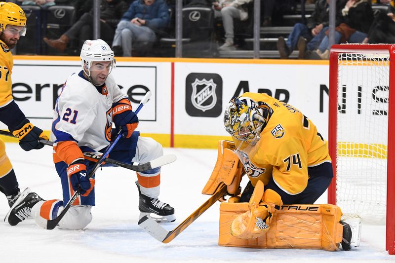 Jan 13, 2024; Nashville, Tennessee, USA; Nashville Predators goaltender Juuse Saros (74) makes a save with pressure from New York Islanders center Kyle Palmieri (21) during the second period at Bridgestone Arena. Mandatory Credit: Christopher Hanewinckel-USA TODAY Sports