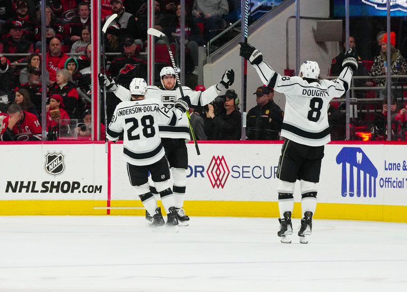 Jan 15, 2024; Raleigh, North Carolina, USA; Los Angeles Kings center Pierre-Luc Dubois (80) is congratulated by  center Jaret Anderson-Dolan (28) and defenseman Drew Doughty (8) after his goal against the Carolina Hurricanes during the third period at PNC Arena. Mandatory Credit: James Guillory-USA TODAY Sports