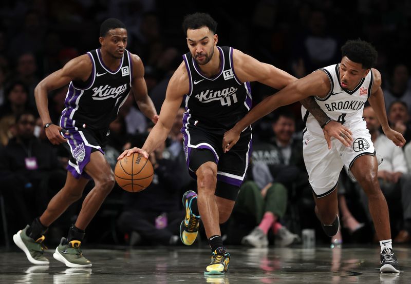 NEW YORK, NEW YORK - JANUARY 27: Trey Lyles #41 of the Sacramento Kings dribbles against Reece Beekman #4 of the Brooklyn Nets during the second half at Barclays Center on January 27, 2025 in the Brooklyn borough of New York City. The Kings won 110-96. NOTE TO USER: User expressly acknowledges and agrees that, by downloading and or using this photograph, User is consenting to the terms and conditions of the Getty Images License Agreement. (Photo by Sarah Stier/Getty Images)