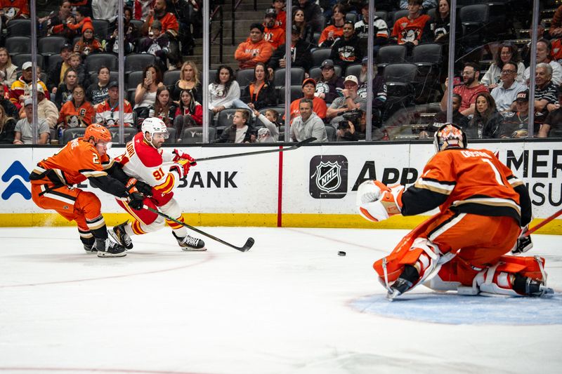 Mar 1, 2026; Anaheim, California, USA; Calgary Flames center Nazem Kadri (91) take a slapshot against Anaheim Ducks goaltender Lukas Dostal (1) in the match at Honda Center. Mandatory Credit: Corinne Votaw-Imagn Images