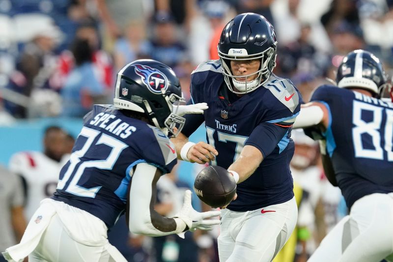 Tennessee Titans quarterback Ryan Tannehill (17) hands off to Tennessee Titans running back Tyjae Spears (32) in the first half of an NFL preseason football game against the New England Patriots Friday, Aug. 25, 2023, in Nashville, Tenn. (AP Photo/George Walker IV)