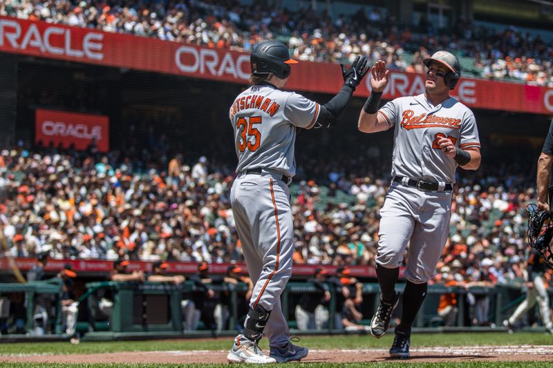 Jun 4, 2023; San Francisco, California, USA;  Baltimore Orioles catcher James McCann (27) is congratulated by designated hitter Adley Rutschman (35) after he scored against the San Francisco Giants during the third inning at Oracle Park. Mandatory Credit: John Hefti-USA TODAY Sports