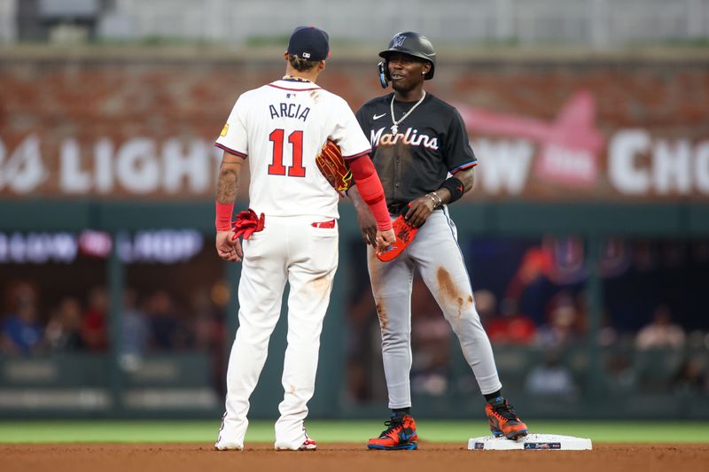 Apr 24, 2024; Atlanta, Georgia, USA; Miami Marlins center fielder Jazz Chisholm Jr. (2) talks to Atlanta Braves shortstop Orlando Arcia (11) in the fourth inning at Truist Park. Mandatory Credit: Brett Davis-USA TODAY Sports