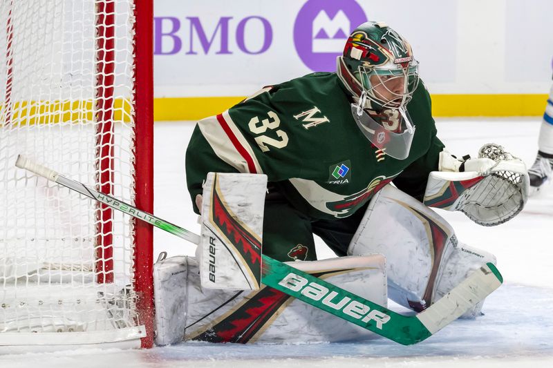 Nov 25, 2024; Saint Paul, Minnesota, USA;  Minnesota Wild goalie Filip Gustavsson (32) tracks the puck against the Winnipeg Jets during the third period at Xcel Energy Center. Mandatory Credit: Nick Wosika-Imagn Images