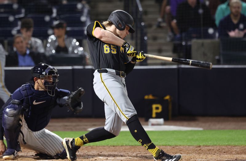 Mar 3, 2025; Tampa, Florida, USA; Pittsburgh Pirates outfielder Jack Suwinski (65) reaches base on error during the third inning against the New York Yankees  at George M. Steinbrenner Field. Mandatory Credit: Kim Klement Neitzel-Imagn Images