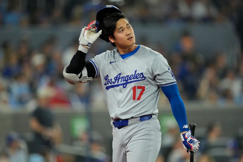 Apr 28, 2024; Toronto, Ontario, CAN; Los Angeles Dodgers designated hitter Shohei Ohtani (17) walks to the dugout after striking out against the Toronto Blue Jays during the sixth inning at Rogers Centre. Mandatory Credit: John E. Sokolowski-USA TODAY Sports