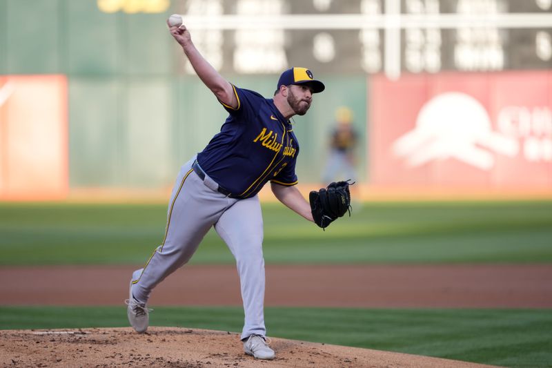 Aug 23, 2024; Oakland, California, USA; Milwaukee Brewers starting pitcher Aaron Civale (32) throws a pitch against the Oakland Athletics during the first inning at Oakland-Alameda County Coliseum. Mandatory Credit: Darren Yamashita-USA TODAY Sports