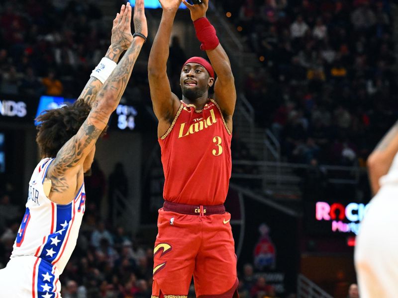 CLEVELAND, OHIO - FEBRUARY 12: Caris LeVert #3 of the Cleveland Cavaliers shoots over Kelly Oubre Jr. #9 of the Philadelphia 76ers at Rocket Mortgage Fieldhouse on February 12, 2024 in Cleveland, Ohio. The 76ers defeated the Cavaliers 123-121. NOTE TO USER: User expressly acknowledges and agrees that, by downloading and or using this photograph, User is consenting to the terms and conditions of the Getty Images License Agreement. (Photo by Jason Miller/Getty Images)