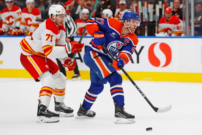 Sep 23, 2024; Edmonton, Alberta, CAN; Edmonton Oilers forward Connor McDavid (97) makes a pass in front of Calgary Flames forward Walker Duehr (71) during the third period at Rogers Place. Mandatory Credit: Perry Nelson-Imagn Images