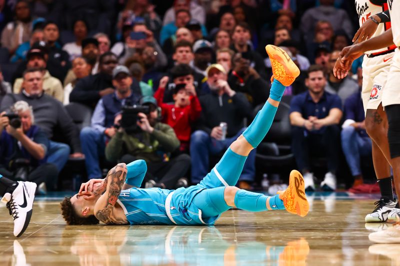 CHARLOTTE, NORTH CAROLINA - NOVEMBER 21: LaMelo Ball #1 of the Charlotte Hornets falls to the ground after taking a hit during the second half of a basketball game against the Detroit Pistons at Spectrum Center on November 21, 2024 in Charlotte, North Carolina. NOTE TO USER: User expressly acknowledges and agrees that, by downloading and or using this photograph, User is consenting to the terms and conditions of the Getty Images License Agreement. (Photo by David Jensen/Getty Images)