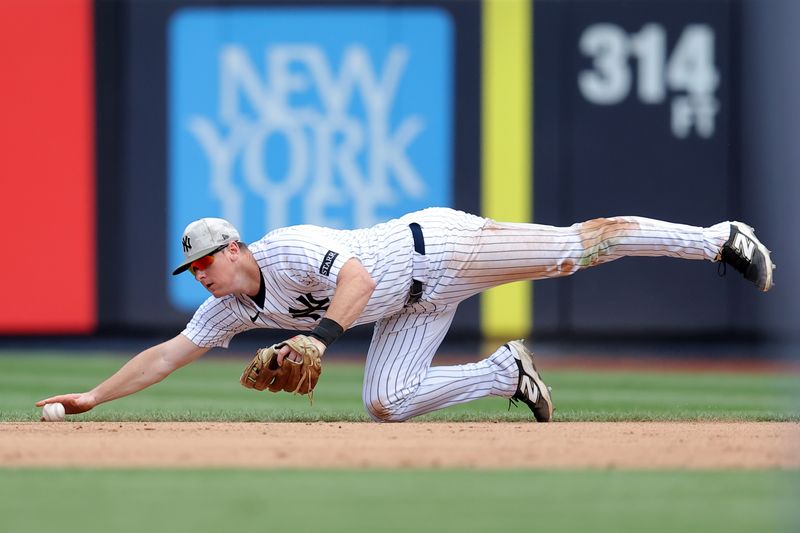 May 17, 2025; Bronx, New York, USA; New York Yankees second baseman DJ LeMahieu (26) can't field a ground ball single by New York Mets third baseman Brett Baty (not pictured) during the ninth inning at Yankee Stadium. Mandatory Credit: Brad Penner-Imagn Images