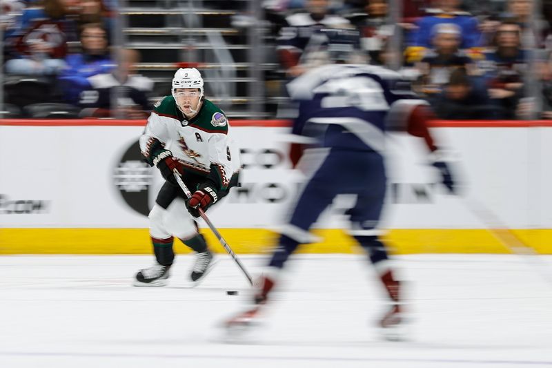 Feb 18, 2024; Denver, Colorado, USA; Arizona Coyotes right wing Clayton Keller (9) controls the puck in the first period against the Colorado Avalanche at Ball Arena. Mandatory Credit: Isaiah J. Downing-USA TODAY Sports