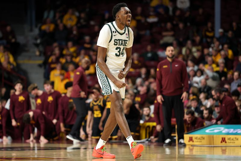 Dec 4, 2024; Minneapolis, Minnesota, USA; Michigan State Spartans forward Xavier Booker (34) celebrates his three-point basket against the Minnesota Golden Gophers during the second half at Williams Arena. Mandatory Credit: Matt Krohn-Imagn Images