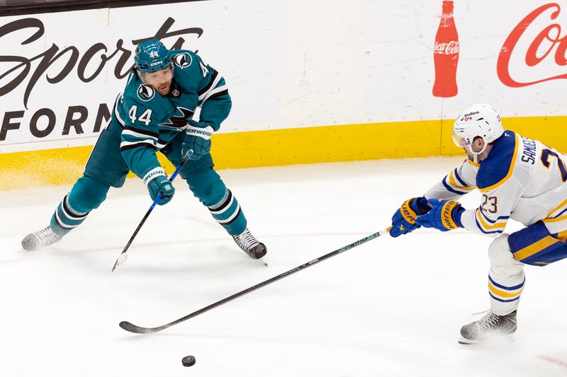 Mar 19, 2026; San Jose, California, USA; San Jose Sharks left wing Kiefer Sherwood (44) passes the puck around the stick of Buffalo Sabres defenseman Mattias Samelsson (23) during the third period at SAP Center at San Jose. Mandatory Credit: D. Ross Cameron-Imagn Images