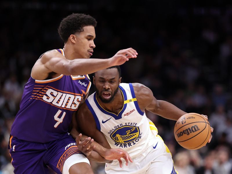 PHOENIX, ARIZONA - NOVEMBER 30: Andrew Wiggins #22 of the Golden State Warriors drives to the basket against Oso Ighodaro #4 of the Phoenix Suns during the second half at Footprint Center on November 30, 2024 in Phoenix, Arizona. NOTE TO USER: User expressly acknowledges and agrees that, by downloading and or using this photograph, User is consenting to the terms and conditions of the Getty Images License Agreement.  (Photo by Chris Coduto/Getty Images)