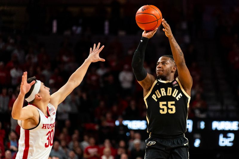 Jan 9, 2024; Lincoln, Nebraska, USA; Purdue Boilermakers guard Lance Jones (55) shoots the ball against Nebraska Cornhuskers guard Keisei Tominaga (30) during the second half at Pinnacle Bank Arena. Mandatory Credit: Dylan Widger-USA TODAY Sports