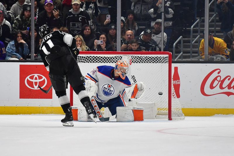 Dec 30, 2023; Los Angeles, California, USA; Edmonton Oilers goaltender Stuart Skinner (74) blocks a shot against Los Angeles Kings center Anze Kopitar (11) during shootout at Crypto.com Arena. Mandatory Credit: Gary A. Vasquez-USA TODAY Sports