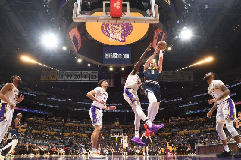 LOS ANGELES, CA - APRIL 27: Christian Braun #0 of the Denver Nuggets drives to the basket during the game against the Los Angeles Lakers during Round 1 Game 4 of the 2024 NBA Playoffs on April 27, 2024 at Crypto.Com Arena in Los Angeles, California. NOTE TO USER: User expressly acknowledges and agrees that, by downloading and/or using this Photograph, user is consenting to the terms and conditions of the Getty Images License Agreement. Mandatory Copyright Notice: Copyright 2024 NBAE (Photo by Andrew D. Bernstein/NBAE via Getty Images)