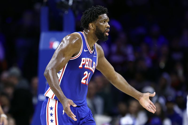 PHILADELPHIA, PENNSYLVANIA - DECEMBER 11: Joel Embiid #21 of the Philadelphia 76ers reacts during the first quarter against the Washington Wizards at the Wells Fargo Center on December 11, 2023 in Philadelphia, Pennsylvania. (Photo by Tim Nwachukwu/Getty Images)