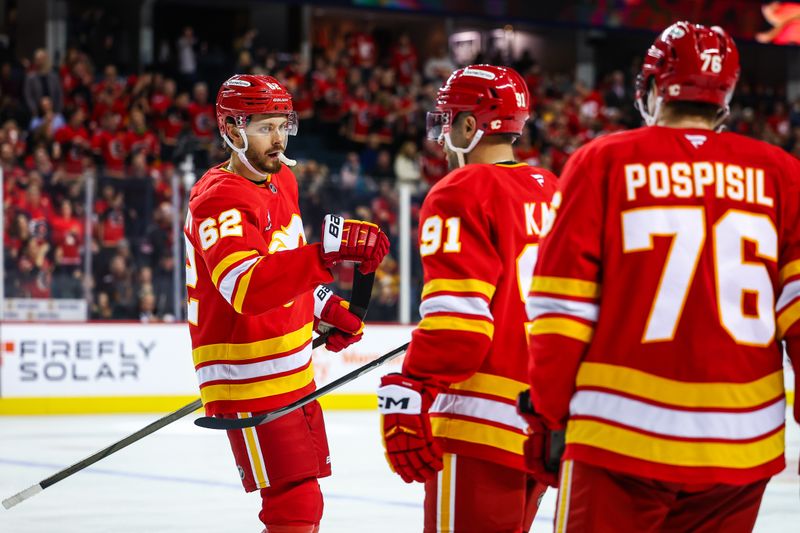 Nov 15, 2024; Calgary, Alberta, CAN; Calgary Flames defenseman Daniil Miromanov (62) celebrates his goal with teammates against the Nashville Predators during the third period at Scotiabank Saddledome. Mandatory Credit: Sergei Belski-Imagn Images