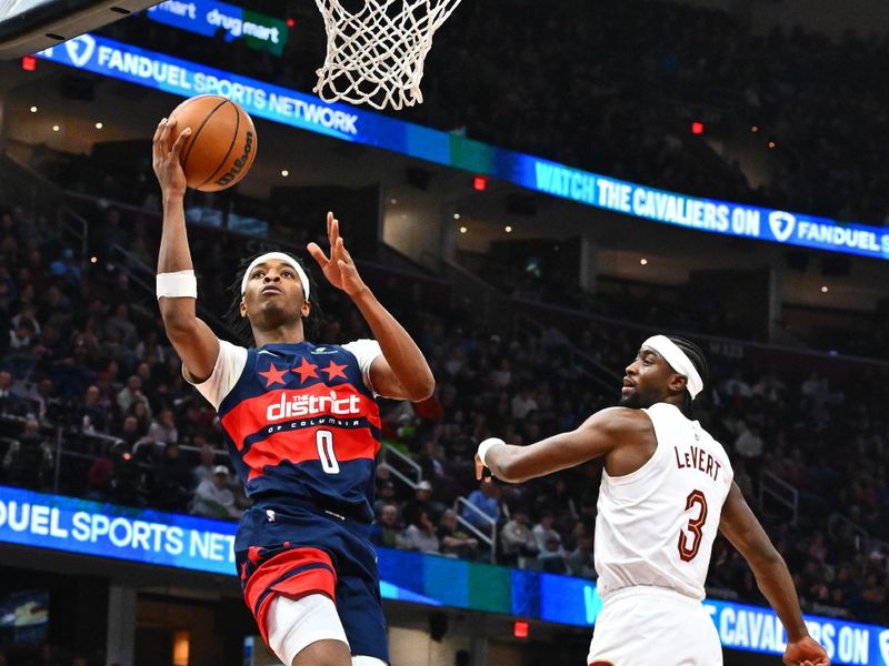 CLEVELAND, OHIO - DECEMBER 13: Bilal Coulibaly #0 of the Washington Wizards shoots over Caris LeVert #3 of the Cleveland Cavaliers during the second quarter at Rocket Mortgage Fieldhouse on December 13, 2024 in Cleveland, Ohio. NOTE TO USER: User expressly acknowledges and agrees that, by downloading and or using this photograph, User is consenting to the terms and conditions of the Getty Images License Agreement. (Photo by Jason Miller/Getty Images)