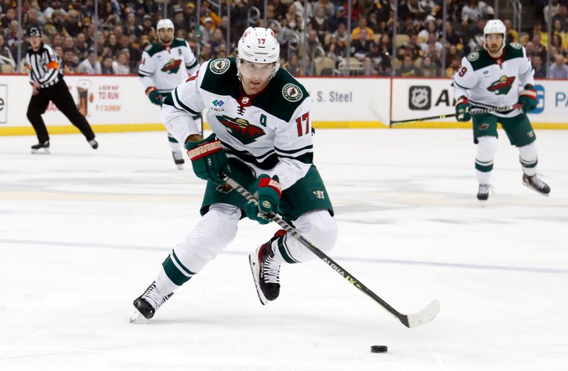 Apr 6, 2023; Pittsburgh, Pennsylvania, USA; Minnesota Wild left wing Marcus Foligno (17) skates with the puck into the offensive zone against the Pittsburgh Penguins during the first period at PPG Paints Arena. Pittsburgh won 4-1. Mandatory Credit: Charles LeClaire-USA TODAY Sports