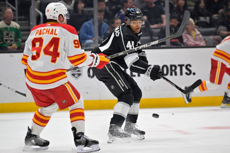 Apr 11, 2024; Los Angeles, California, USA; Los Angeles Kings center Akil Thomas (41) gets the puck past Calgary Flames defenseman Brayden Pachal (94) for a goal in the second period at Crypto.com Arena. Mandatory Credit: Jayne Kamin-Oncea-USA TODAY Sports