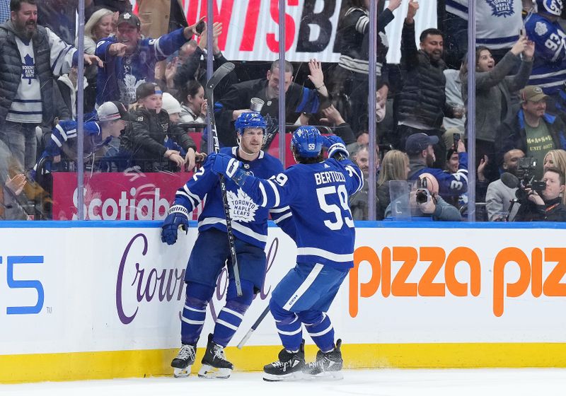 Apr 8, 2024; Toronto, Ontario, CAN; Toronto Maple Leafs defenseman Jake McCabe (22) scores the winning goal and celebrates with left wing Tyler Bertuzzi (59) against the Pittsburgh Penguins during the overtime period at Scotiabank Arena. Mandatory Credit: Nick Turchiaro-USA TODAY Sports