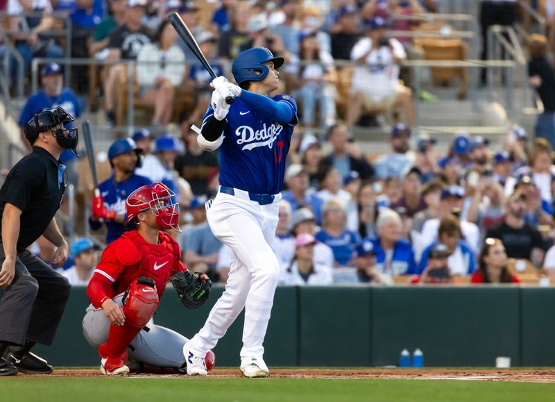 Feb 28, 2025; Phoenix, Arizona, USA; Los Angeles Dodgers designated hitter Shohei Ohtani (17) hits a leadoff home run against the Los Angeles Angels during a spring training game at Camelback Ranch-Glendale. Mandatory Credit: Mark J. Rebilas-Imagn Images