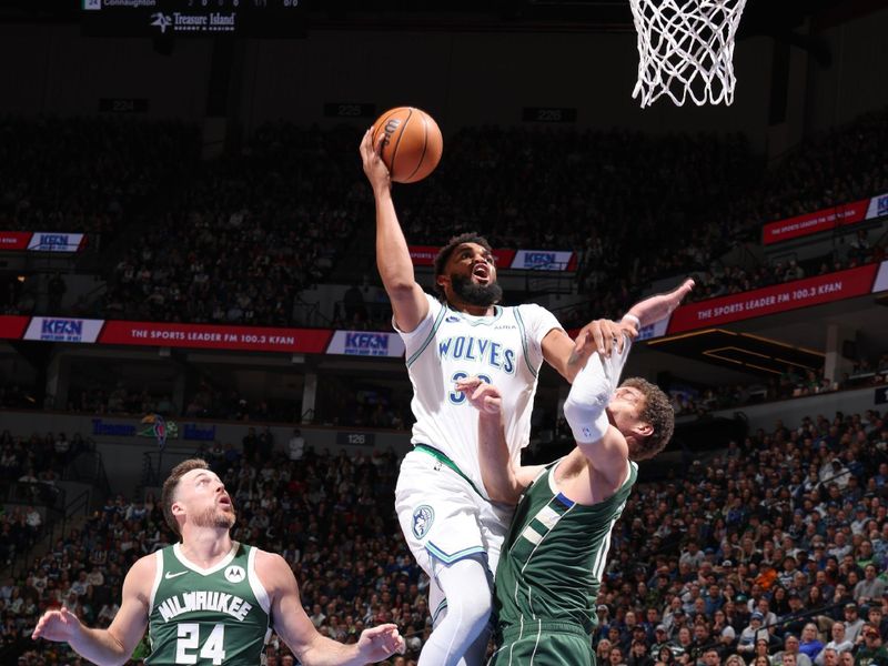 MINNEAPOLIS, MN -  FEBRUARY 23: Karl-Anthony Towns #32 of the Minnesota Timberwolves goes to the basket during the game on February 23, 2024 at Target Center in Minneapolis, Minnesota. NOTE TO USER: User expressly acknowledges and agrees that, by downloading and or using this Photograph, user is consenting to the terms and conditions of the Getty Images License Agreement. Mandatory Copyright Notice: Copyright 2024 NBAE (Photo by David Sherman/NBAE via Getty Images)