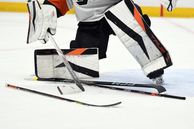 Dec 12, 2023; Nashville, Tennessee, USA; Philadelphia Flyers goaltender Samuel Ersson (33) grabs his stick from a pile left in front of the net after a scrum during the first period against the Nashville Predators at Bridgestone Arena. Mandatory Credit: Christopher Hanewinckel-USA TODAY Sports