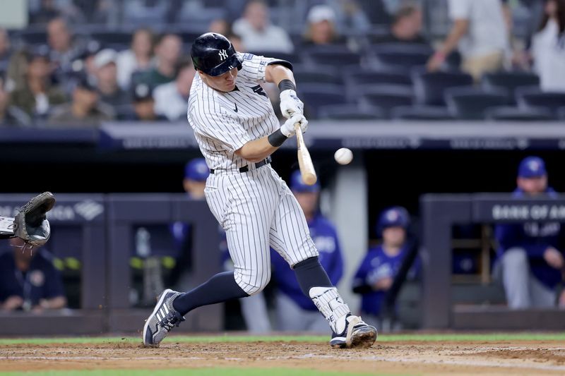 Sep 21, 2023; Bronx, New York, USA; New York Yankees shortstop Anthony Volpe (11) hits a double against the Toronto Blue Jays during the fourth inning at Yankee Stadium. Mandatory Credit: Brad Penner-USA TODAY Sports