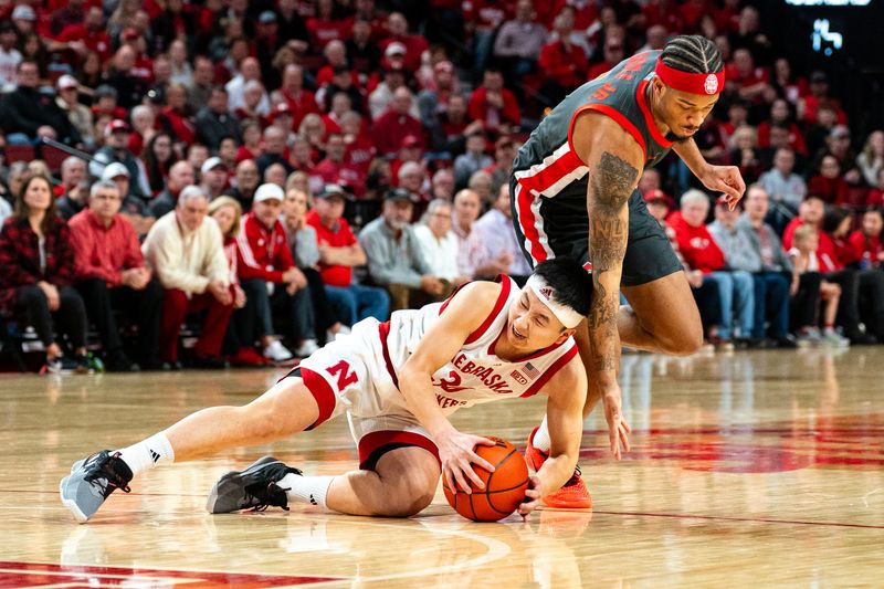 Jan 23, 2024; Lincoln, Nebraska, USA; Nebraska Cornhuskers guard Keisei Tominaga (30) fights for a loose ball against Ohio State Buckeyes guard Roddy Gayle Jr. (1) during the second half at Pinnacle Bank Arena. Mandatory Credit: Dylan Widger-USA TODAY Sports