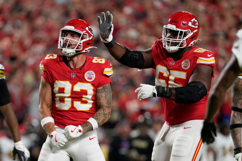 Kansas City Chiefs tight end Noah Gray (83) is congratulated by guard Trey Smith (65) after catching a pass during the first half of an NFL football game against the New Orleans Saints Monday, Oct. 7, 2024, in Kansas City, Mo. (AP Photo/Ed Zurga)