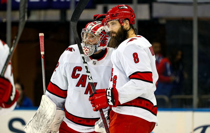 Jan 2, 2024; New York, New York, USA; Carolina Hurricanes goalie Pyotr Kochetkov (52) celebrates a 6-1 win against the New York Rangers with defenseman Brent Burns (8) at Madison Square Garden. Mandatory Credit: Danny Wild-USA TODAY Sports