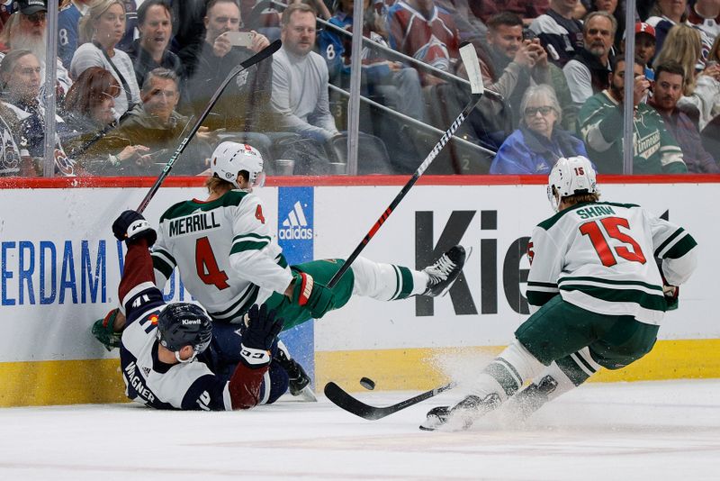 Apr 9, 2024; Denver, Colorado, USA; Colorado Avalanche right wing Chris Wagner (14) and Minnesota Wild defenseman Jon Merrill (4) get tied up as center Mason Shaw (15) chases down a loose puck in the first period at Ball Arena. Mandatory Credit: Isaiah J. Downing-USA TODAY Sports