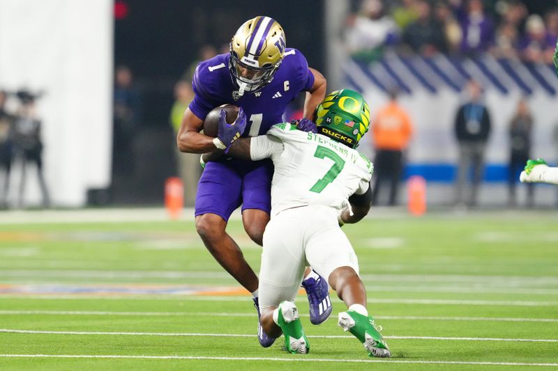 Dec 1, 2023; Las Vegas, NV, USA; Washington Huskies wide receiver Rome Odunze (1) is tackled by Oregon Ducks defensive back Steve Stephens IV (7) during the first quarter at Allegiant Stadium. Mandatory Credit: Stephen R. Sylvanie-USA TODAY Sports