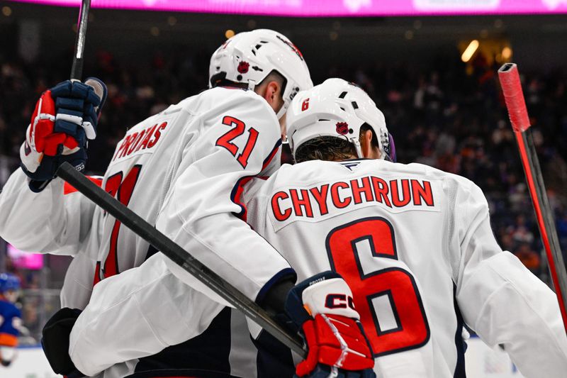 Nov 30, 2025; Elmont, New York, USA;  Washington Capitals center Aliaksei Protas (21) celebrates his empty net goal against the New York Islanders with Washington Capitals defenseman Jakob Chychrun (6) during the third period at UBS Arena. Mandatory Credit: Dennis Schneidler-Imagn Images