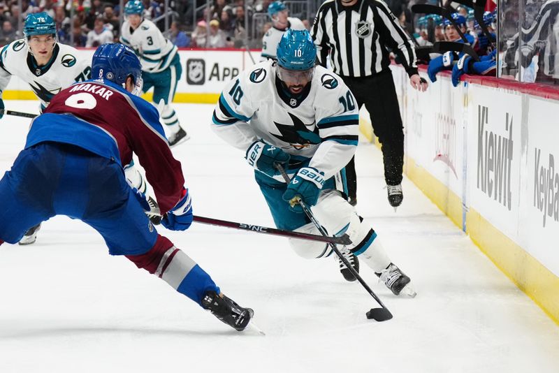 Dec 31, 2023; Denver, Colorado, USA; San Jose Sharks left wing Anthony Duclair (10) skates toward Colorado Avalanche defenseman Cale Makar (8) in the third period at Ball Arena. Mandatory Credit: Ron Chenoy-USA TODAY Sports