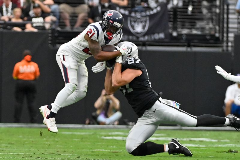 Houston Texans cornerback Steven Nelson, above, breaks up a pass intended for Las Vegas Raiders tight end Foster Moreau, below, during the first half of an NFL football game Sunday, Oct. 23, 2022, in Las Vegas. (AP Photo/David Becker)