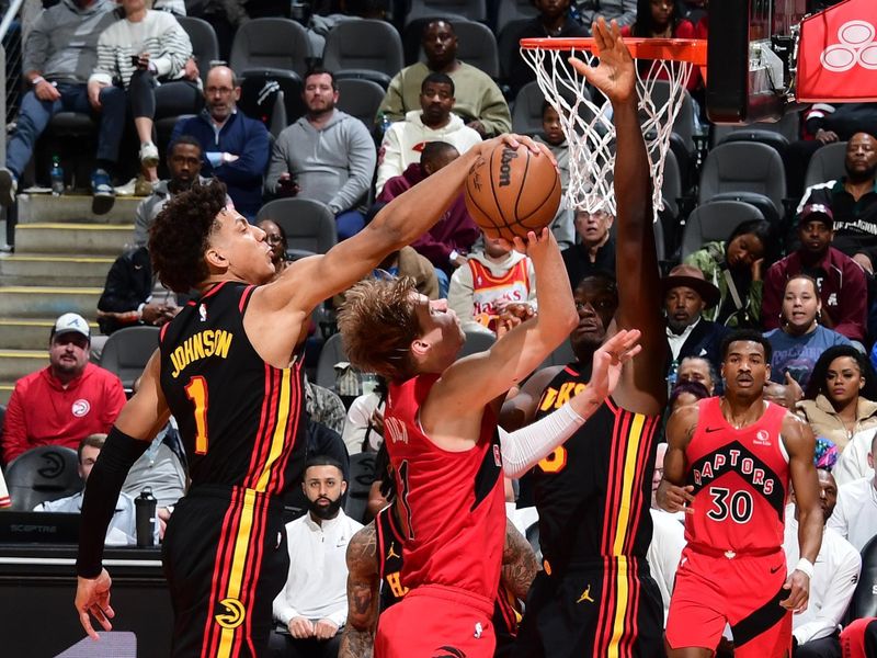 ATLANTA, GA - February 23:  Jalen Johnson #1 of the Atlanta Hawks blocks the shot of Gradey Dick #1 of the Toronto Raptors on February 23, 2024 at State Farm Arena in Atlanta, Georgia.  NOTE TO USER: User expressly acknowledges and agrees that, by downloading and/or using this Photograph, user is consenting to the terms and conditions of the Getty Images License Agreement. Mandatory Copyright Notice: Copyright 2024 NBAE (Photo by Scott Cunningham/NBAE via Getty Images)