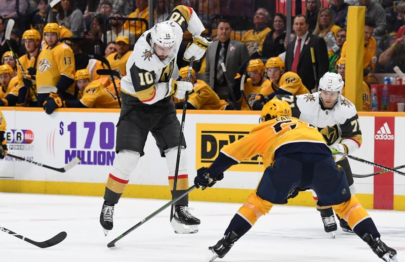 Apr 4, 2023; Nashville, Tennessee, USA; Vegas Golden Knights center Nicolas Roy (10) passes the puck through the neutral zone during the second period against the Nashville Predators at Bridgestone Arena. Mandatory Credit: Christopher Hanewinckel-USA TODAY Sports