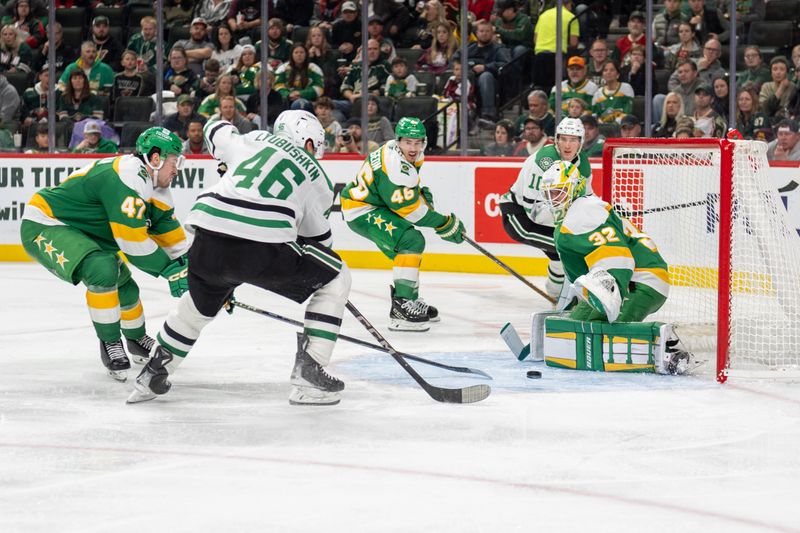 Nov 16, 2024; Saint Paul, Minnesota, USA; Dallas Stars defenseman Ilya Lyubushkin (46) shoots against Minnesota Wild defenseman Declan Chisholm (47) and goaltender Filip Gustavsson (32) in the third period at Xcel Energy Center. Mandatory Credit: Matt Blewett-Imagn Images