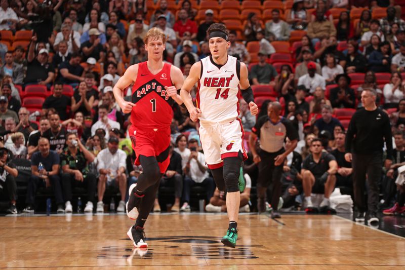 MIAMI, FL - APRIL 12: Gradey Dick #1 of the Toronto Raptors and Tyler Herro #14 of the Miami Heat look on during the game  on April 12, 2024 at Kaseya Center in Miami, Florida. NOTE TO USER: User expressly acknowledges and agrees that, by downloading and or using this Photograph, user is consenting to the terms and conditions of the Getty Images License Agreement. Mandatory Copyright Notice: Copyright 2024 NBAE (Photo by Issac Baldizon/NBAE via Getty Images)