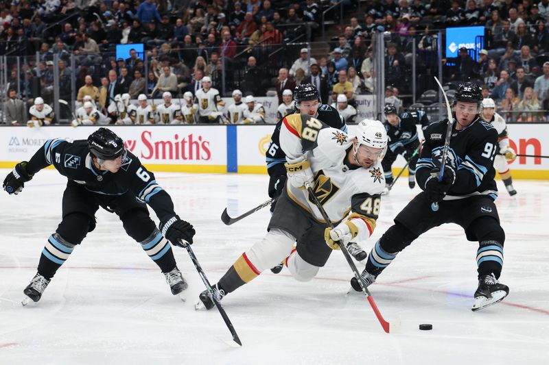 Nov 24, 2025; Salt Lake City, Utah, USA; Vegas Golden Knights center Tomas Hertl (48) moves the puck against Utah Mammoth defenseman John Marino (6) and center Logan Cooley (92) during the second period at Delta Center. Mandatory Credit: Rob Gray-Imagn Images