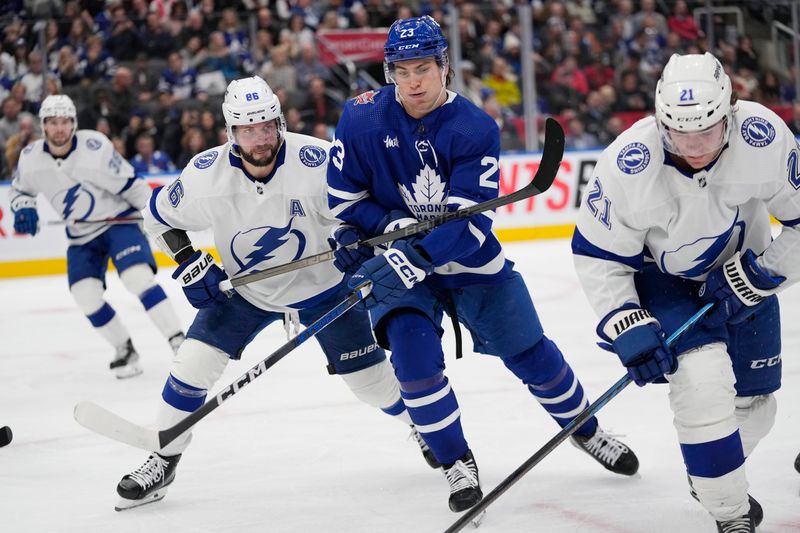 Nov 6, 2023; Toronto, Ontario, CAN; Toronto Maple Leafs forward Matthew Knies (23) and Tampa Bay Lightning forward Nikita Kucherov (86) battle for position during the third period at Scotiabank Arena. Mandatory Credit: John E. Sokolowski-USA TODAY Sports