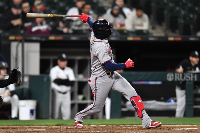 Apr 2, 2024; Chicago, Illinois, USA; Atlanta Braves shortstop Orlando Arcia (11) singles during the fifth inning against the Chicago White Sox at Guaranteed Rate Field. Mandatory Credit: Patrick Gorski-USA TODAY Sports