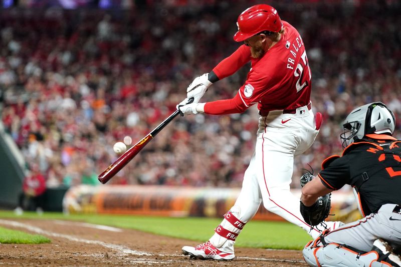 May 5, 2024; Cincinnati, Ohio, USA; Cincinnati Reds outfielder Jake Fraley (27) hits as single in the ninth inning against the Baltimore Orioles at Great American Ball Park in Cincinnati. Mandatory Credit: Kareem Elgazzar-USA TODAY Sports