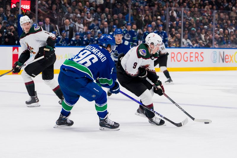 Jan 18, 2024; Vancouver, British Columbia, CAN; Vancouver Canucks forward Andrei Kuzmenko (96) checks Arizona Coyotes forward Clayton Keller (9) in the second period at Rogers Arena. Mandatory Credit: Bob Frid-USA TODAY Sports